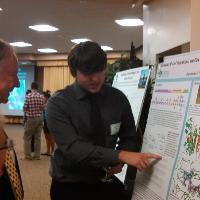 Ben Nicholson explaining his research during a poster presentation at S3 Showcase